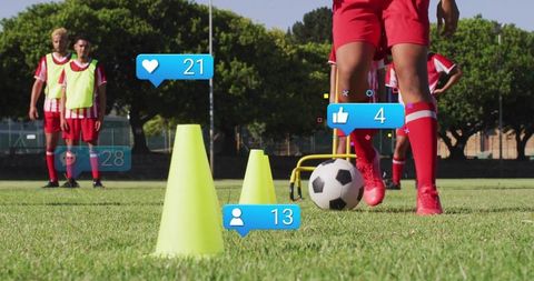 Youth soccer player dribbling through cones with social media icons outdoor training drill