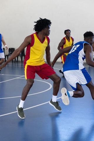 Competitive Basketball Players in Mid-Game Action