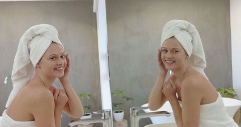 Woman Admiring Reflection in Minimalist Bathroom