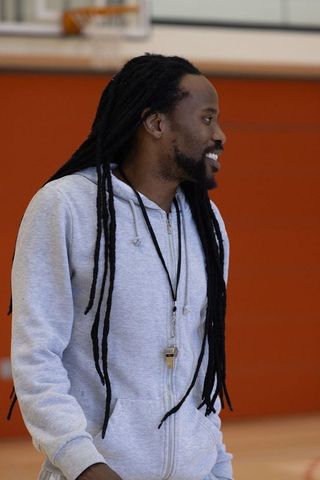 Smiling Sports Coach on Gym Court with Whistle Lanyard