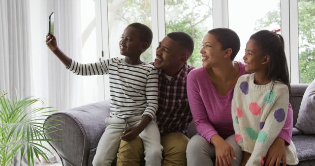 Happy Family of Four Taking Selfie on Couch in Living Room - Download Free Stock Images Pikwizard.com