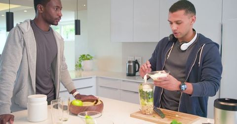 Diverse Young Men Preparing Green Smoothie at Bright Modern Kitchen for Healthy Lifestyle