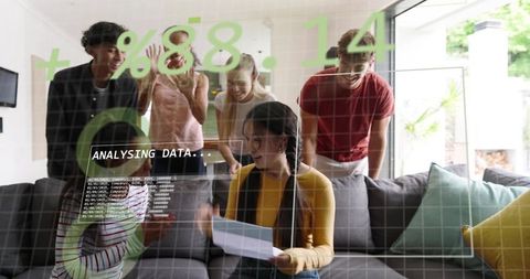 Young team analyzing data overlay on living room sofa, celebrating collaborative insight