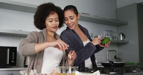 Same-Sex Couple Cooking Together in Modern Kitchen