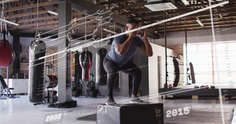Explosive boxer jumping on 20in plyo box in gritty boxing gym with hud metrics overlay