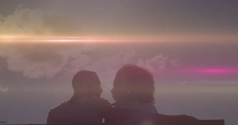 Romantic Couple Enjoying Serene Sunset Vista from Seaside Bench