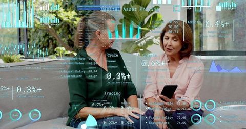 Two mature women reviewing financial data on smartphone with HUD charts on outdoor terrace