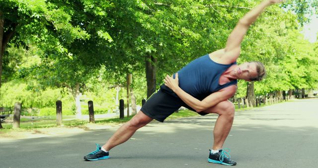 Man Stretching Outdoors in Sunny Park - Download Free Stock Images Pikwizard.com