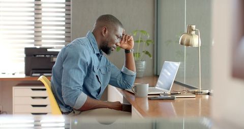 Focused professional paring at laptop in contemporary office space