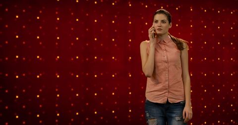 woman talking on smartphone with geometric red backdrop - Download Free Stock Images Pikwizard.com