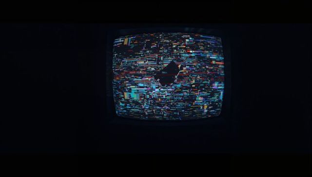 Vintage CRT Monitor Displaying Glitch Static in Dark Room