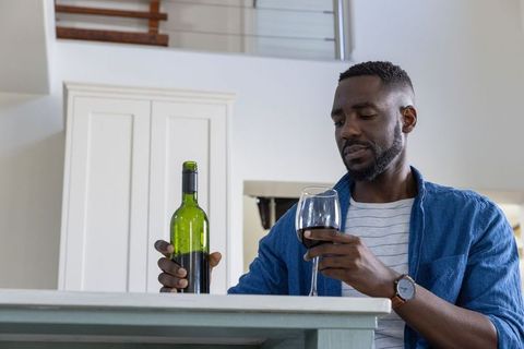 Man Relaxing at Home with Red Wine
