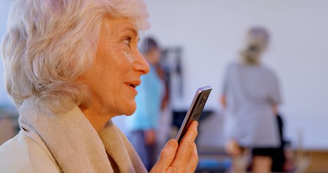 Senior woman using smartphone in futuristic voice activation - Download Free Stock Images Pikwizard.com