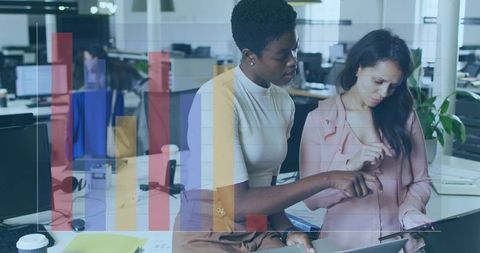 Female Colleagues Collaborating Over Tablet with Data Chart Overlay in Open Office