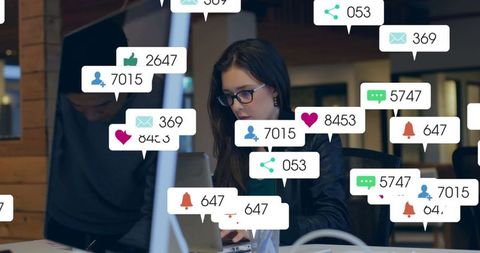 Businesswoman on laptop surround by digital notification icons