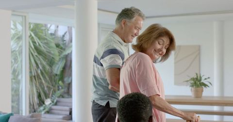 Senior Couple Smiling Together at Home with Walking Cane