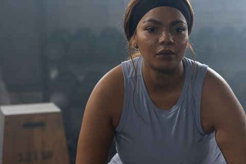 African american woman training in gym showing focus determination and strength