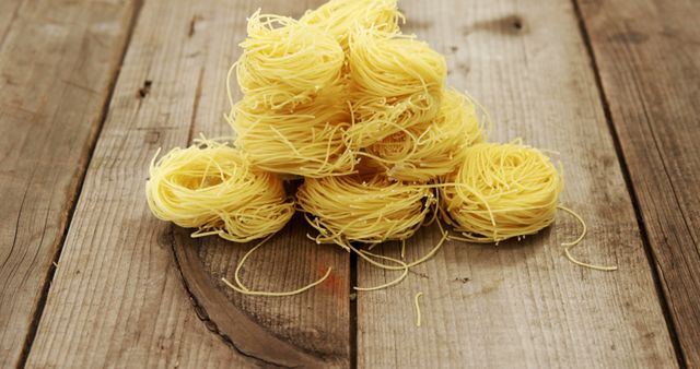 Nest Pasta Pile on Rustic Wooden Table - Download Free Stock Images Pikwizard.com