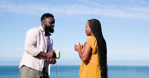 Couple Enjoying Morning Coffee with Ocean View