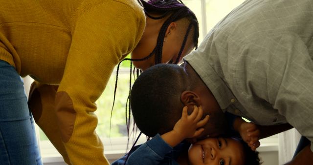 Loving Family Embracing Young Child in Bright Home - Download Free Stock Images Pikwizard.com