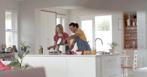Diverse Couple Cooking Together in Bright Modern Kitchen