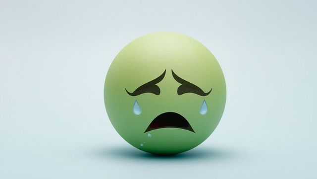 Green emotive sphere with tears expressing sadness