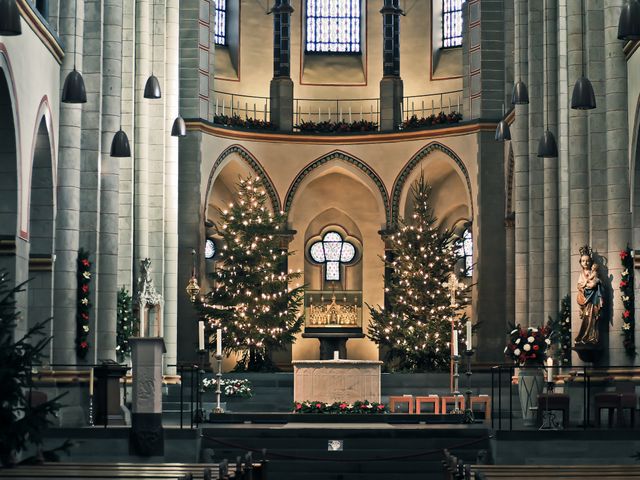 Interior of a church decorated for Christmas with lit Christmas trees and festive ornaments, highlighting the altar and beautiful architectural features. Ideal for illustrations of religious celebrations, festive event invitations, web designs about holiday worship, or articles on Christmas traditions and church services.
