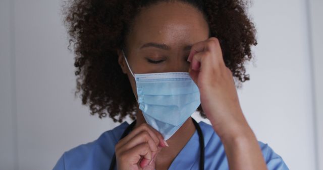 Tired Healthcare Worker Removing Face Mask After Shift - Download Free Stock Images Pikwizard.com