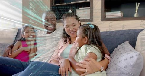 Smiling family cuddling on sofa with hud data overlay, cozy modern home bonding moment