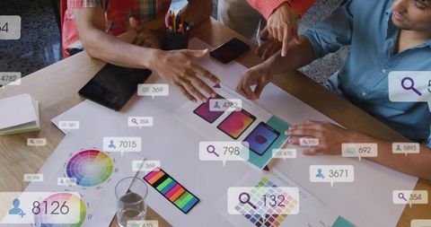 Designers reviewing mobile ui mockups and color palettes, collaborating on app prototype