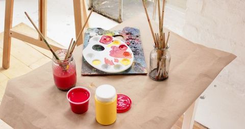 Creative art workspace with paint supplies by window