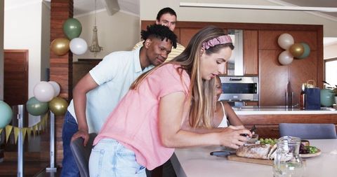 Friends Setting Dining Table During Home Celebration