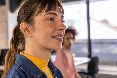 Confident Modern Professional Woman Collaborating in Open-Plan Workspace