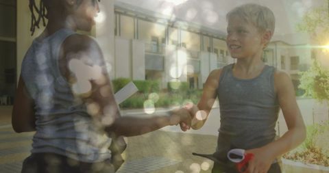 Happy Diverse Schoolboys Shaking Hands After Sports in Sunlight