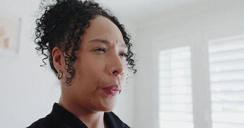 Pensive woman receiving digital health alert with animated heart overlay, telemedicine