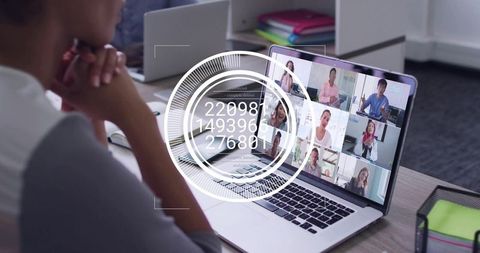 Mature professional attending virtual meeting with HUD data overlay on laptop screen