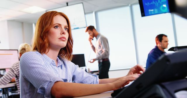 Focused Businesswoman Typing on Keyboard in Modern Office - Download Free Stock Images Pikwizard.com