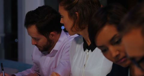 Focused professionals engaging in collaborative meeting