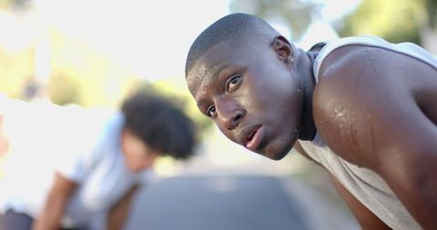 Young Athlete Catching Breath After Run in Park