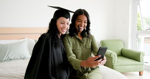 Mother and Daughter Celebrating Graduation with Selfie and Smiles