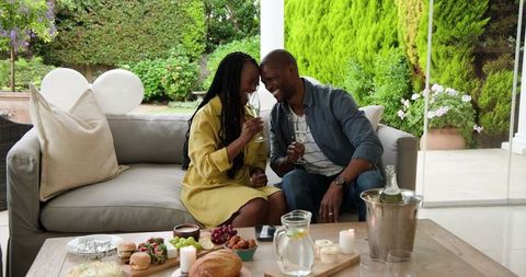 Couple Enjoying Intimate Patio Picnic with Champagne