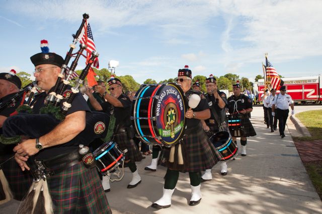 The Brevard Police and Fire Pipe and Drum corps open the dedication service for a memorial to the 343 first responder victims of the Sept. 11, 2001, terror attacks at Fire Station 1 at NASA's Kennedy Space Center on Sept. 11, 2015. The ceremony dedicated a monument that includes a section of steel I-beam from the World Trade Center in New York.