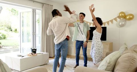 Diverse Friends Celebrating Together at Home with Balloons