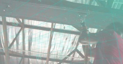 Inspecting overhead metal trusses in hangar with teal ar grid overlay and silhouette