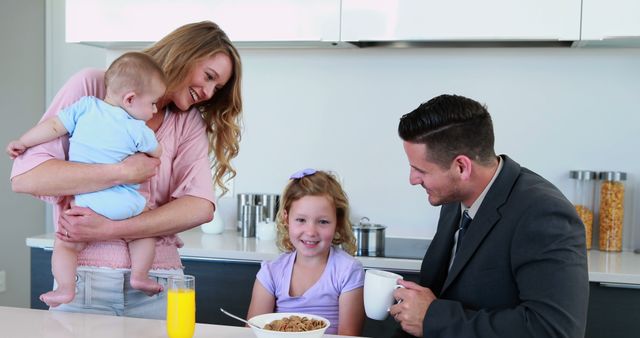 Happy Family Eating Breakfast Together in Modern Kitchen - Download Free Stock Images Pikwizard.com