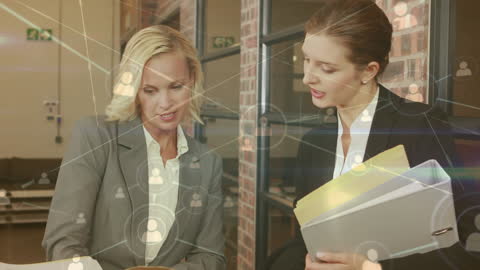 Businesswomen Analyzing Data with Digital Network Overlay