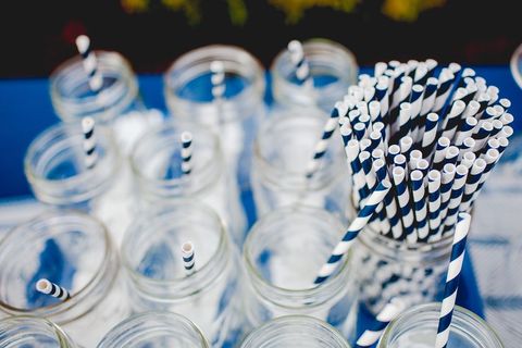 Striped paper straws in glass jars at outdoor event