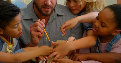 Diverse children learning anatomy with teacher