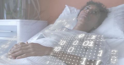 Mature woman resting in bed with binary overlay representing digital health monitoring