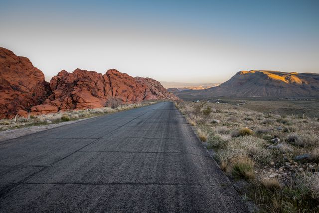 Desert Highway Passing Through Rocky Landscape During Sunrise - Download Free Stock Photos Pikwizard.com